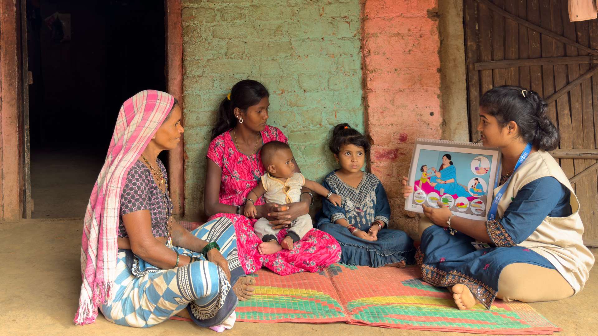 Action Against Hunger worker training families in India.