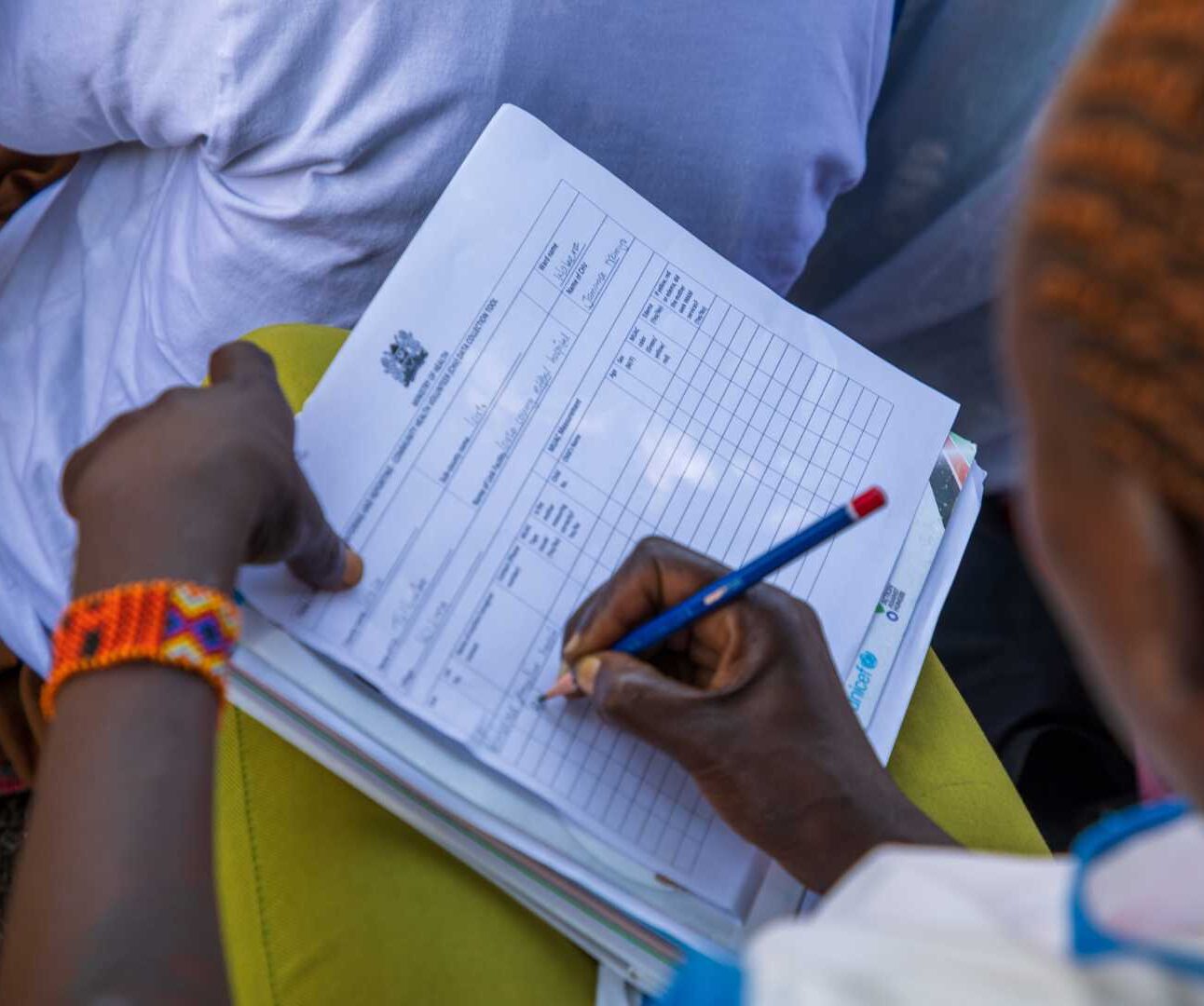 Woman undertaking nutrition assessment in Kenya.