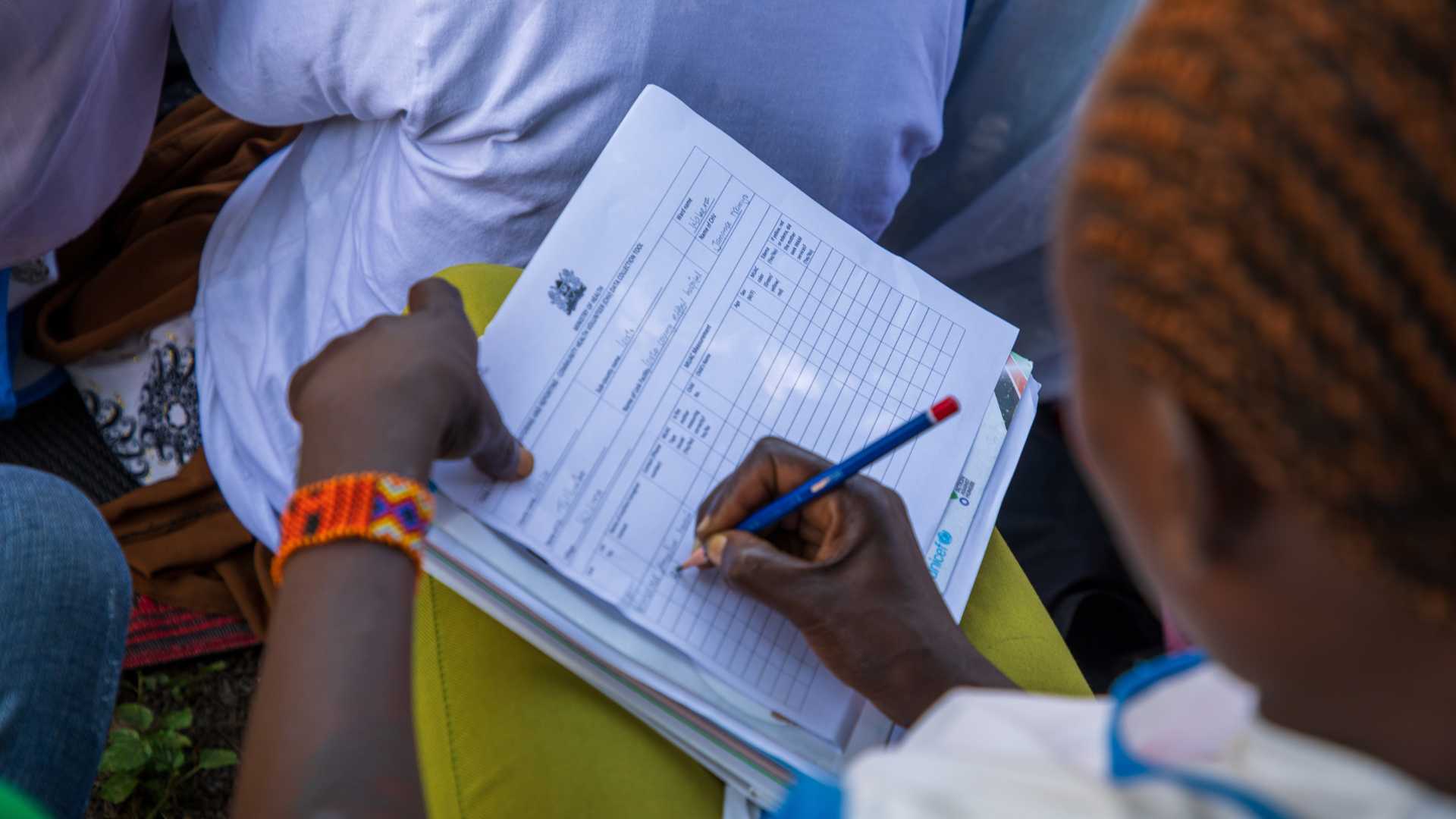 Woman undertaking nutrition assessment in Kenya.