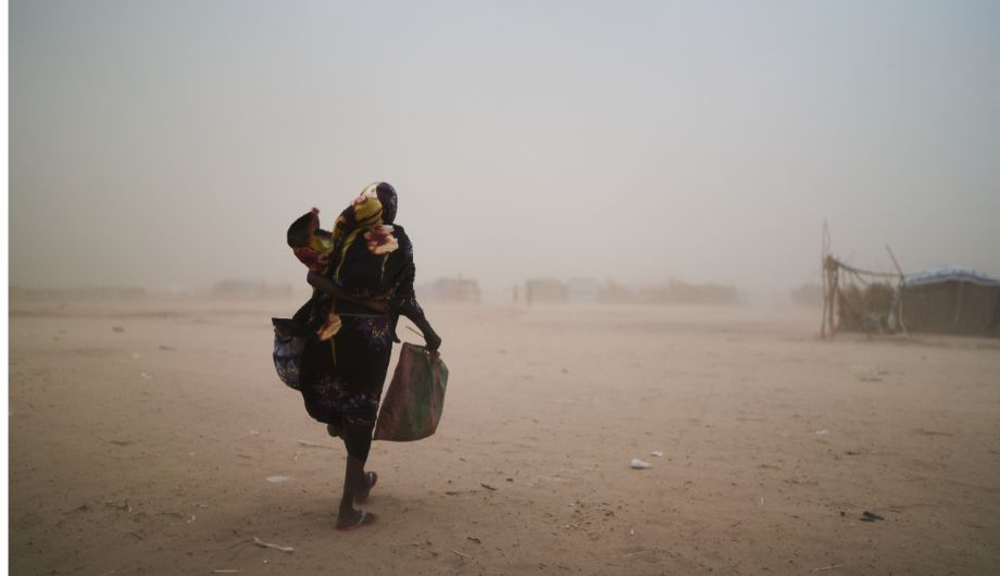 Women fleeing Sudan holding her child.