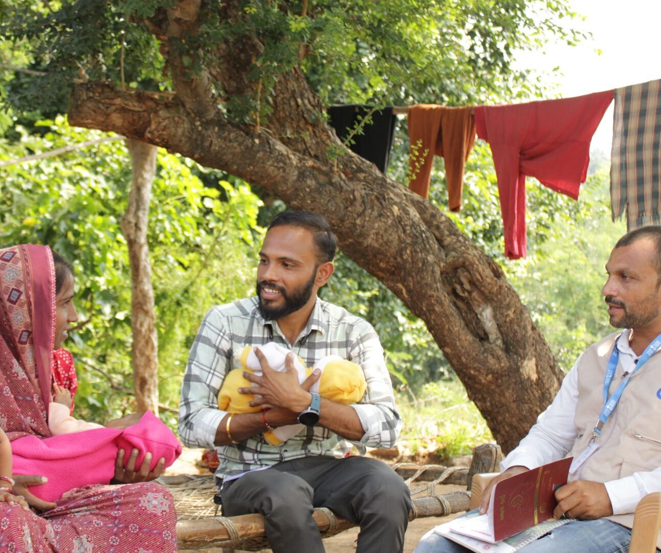 Two Action Against Hunger workers with community members in Kenya.