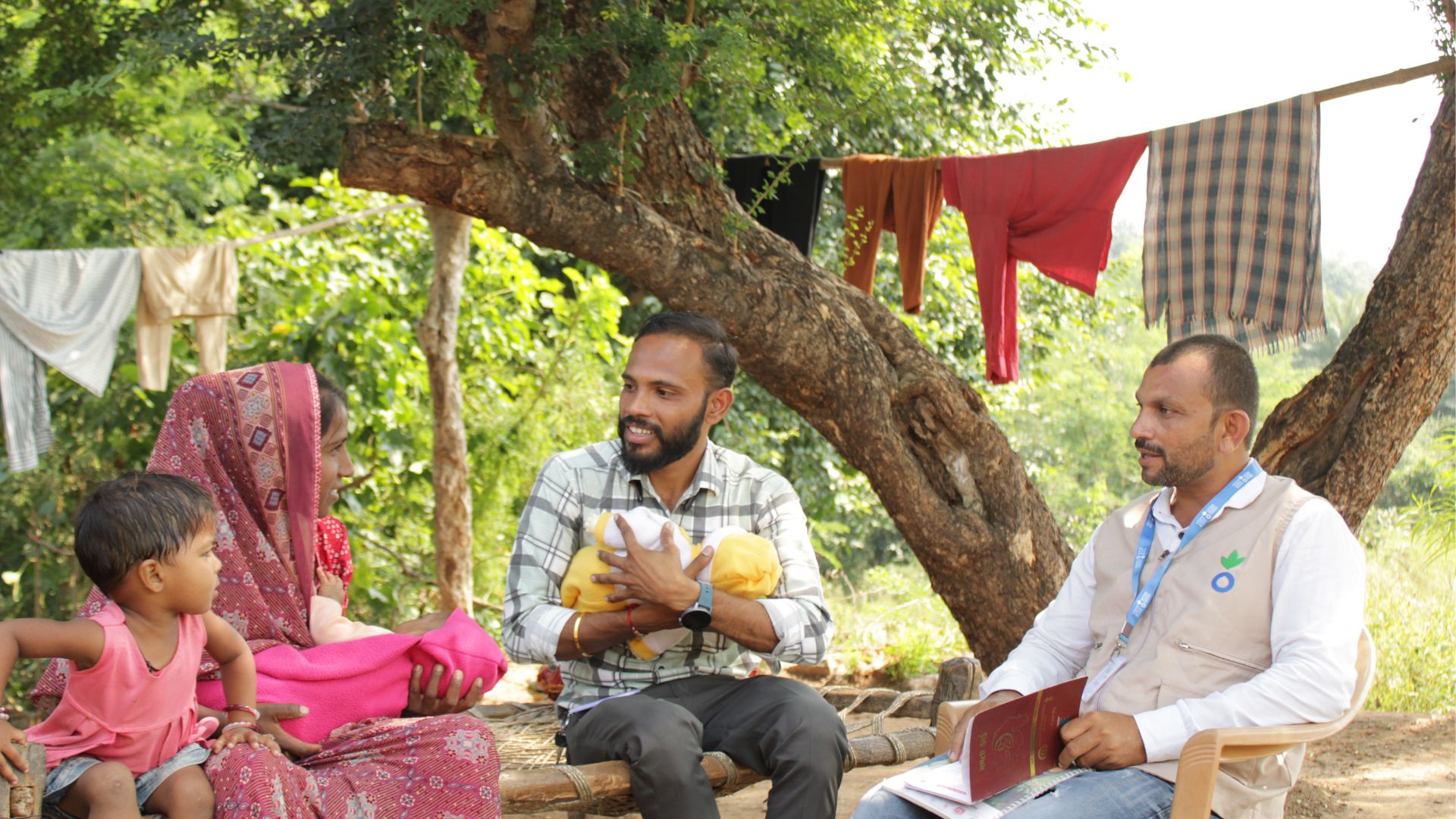 Two Action Against Hunger workers with community members in Kenya.