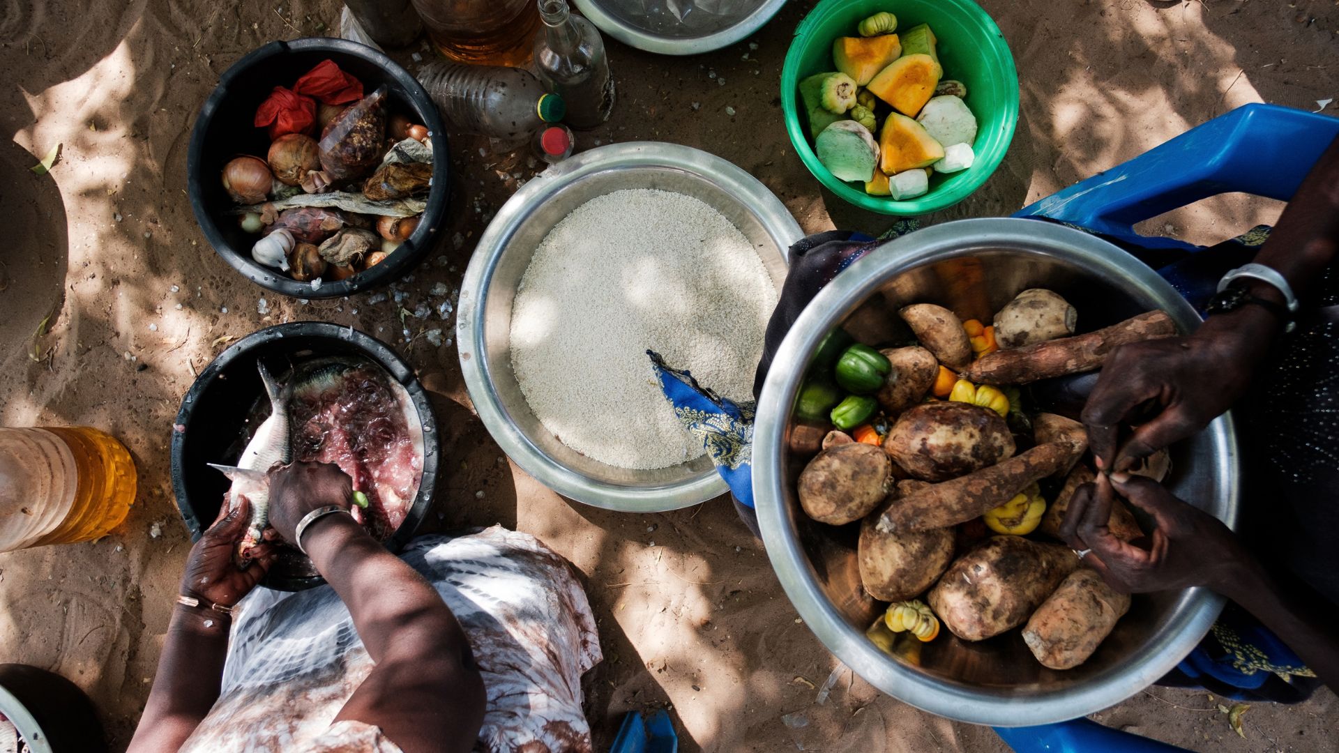 Women prepare food together at a community project supported by Action Against Hunger in Senegal.